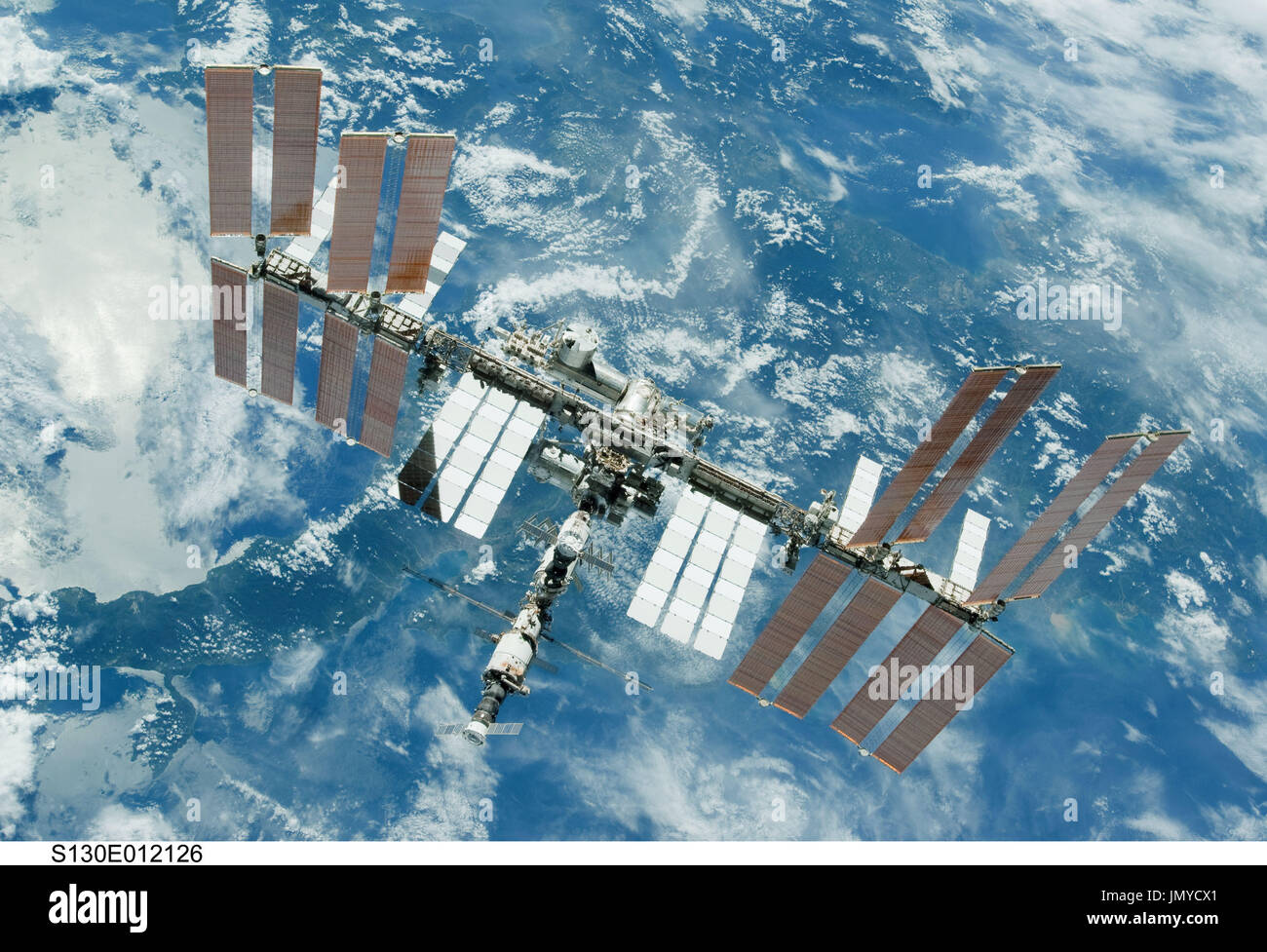 Backdropped by a blue and white part of Earth, the International Space ...