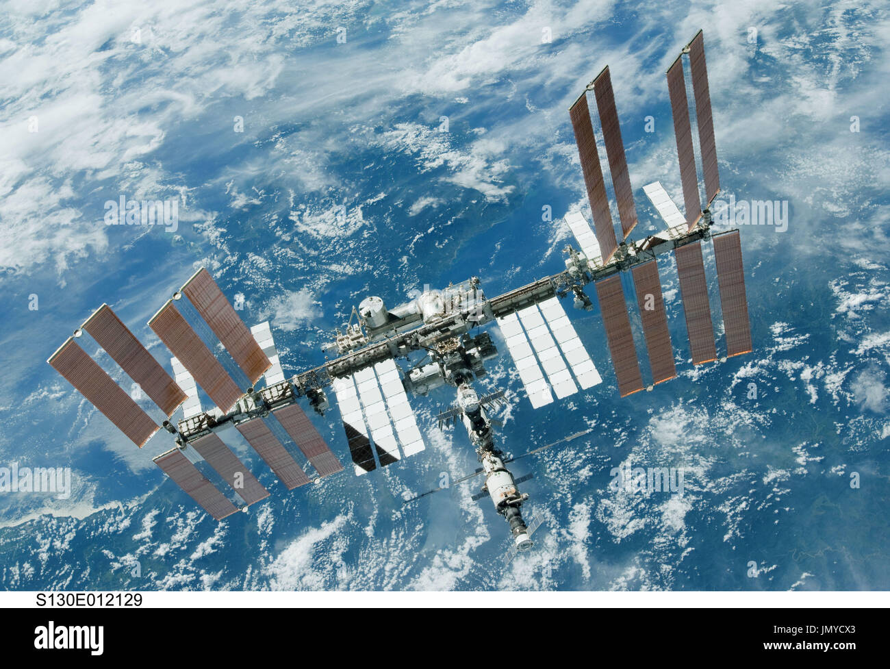 Backdropped by a blue and white part of Earth, the International Space ...