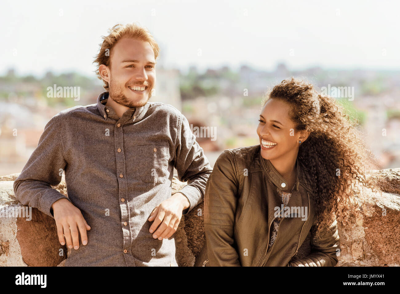 Smiling Young Mixed Race Girl With Caucasian Friend Standing And