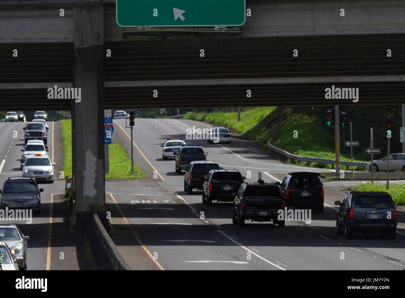 United States President Barack Obama's motorcade rides along the Kamehameha Highway in his