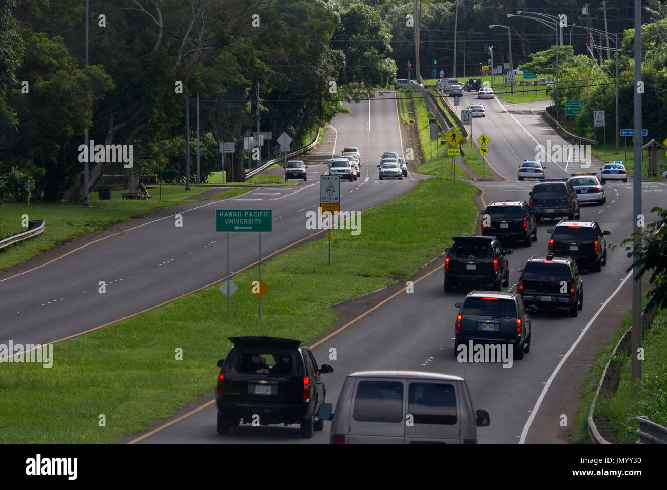 United States President Barack Obama's motorcade rides along the Kamehameha Highway in his