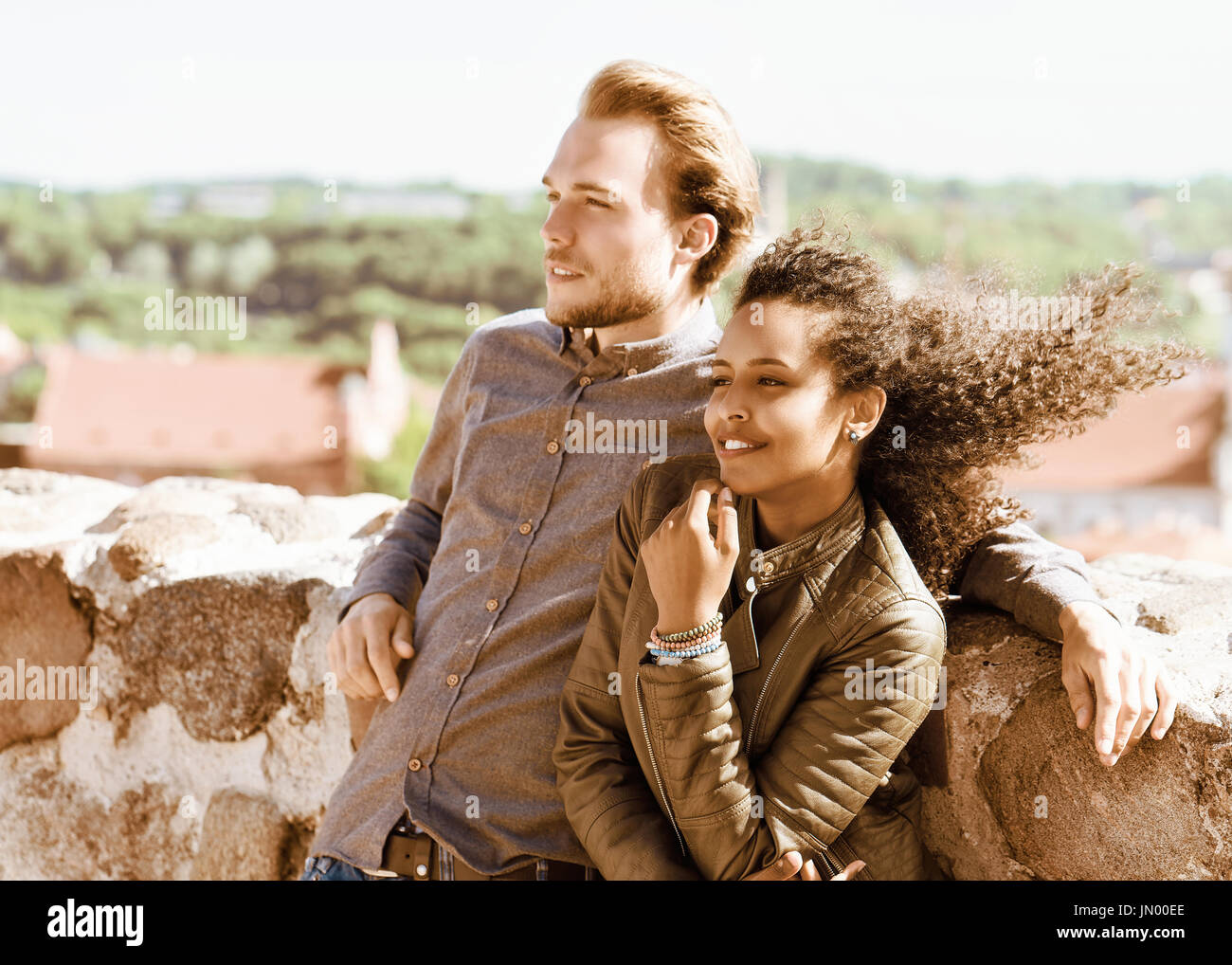 Young mixed race girl and her caucasian friend standing and relaxing ...