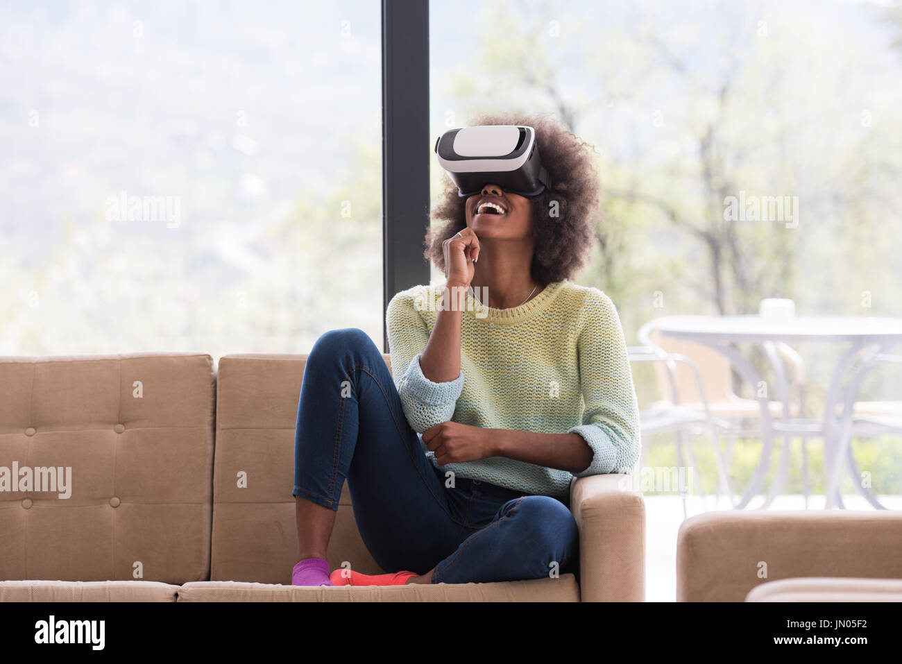 Happy african american girl getting experience using VR headset glasses ...
