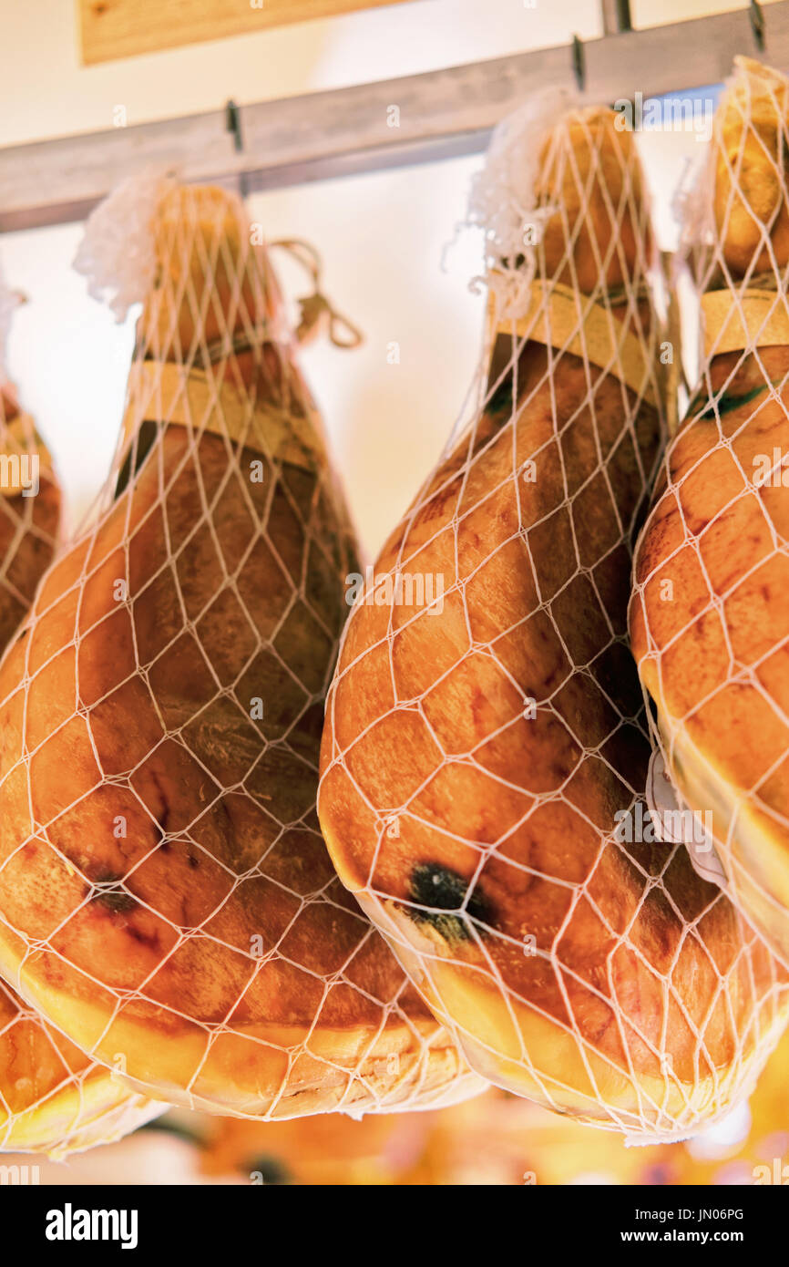 Hanging legs of Traditional cured italian ham casserole and prosciutto