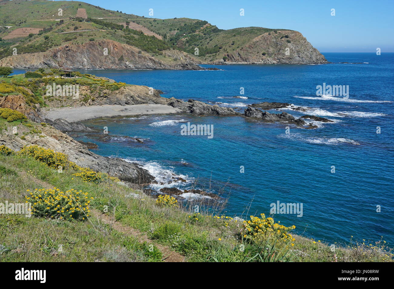 Rocky coast with small pebble beach, Mediterranean sea, south of France, Pyrenees Orientales, Roussillon, Cote Vermeille, Cap Peyrefite Stock Photo