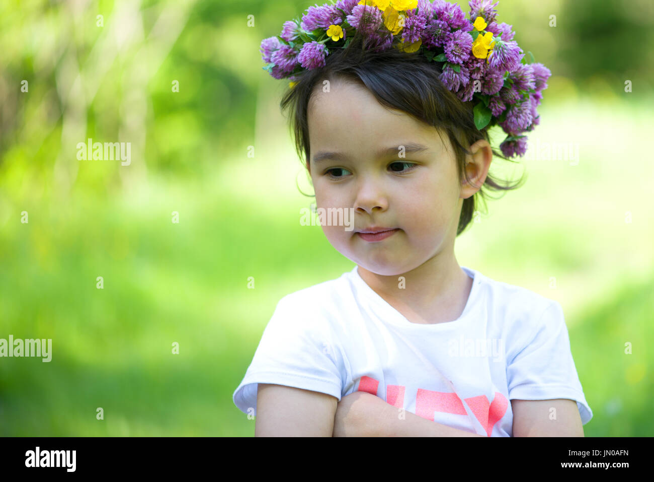 Portrait of a cheerful girl with a wreath of flowers on her head Stock ...