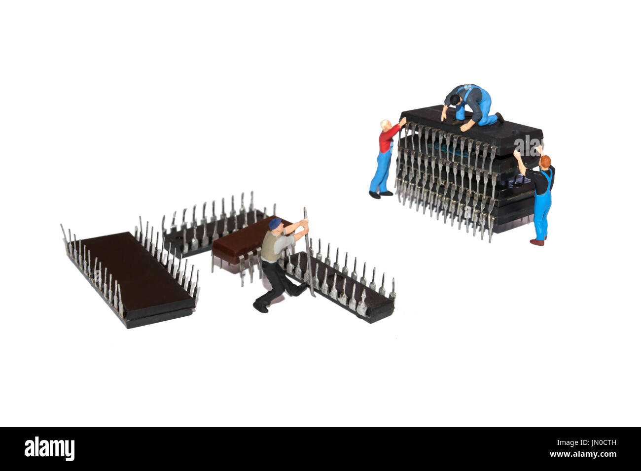 Creative concept with Miniature people. Team workers and microchips. Repair of machinery Stock Photo