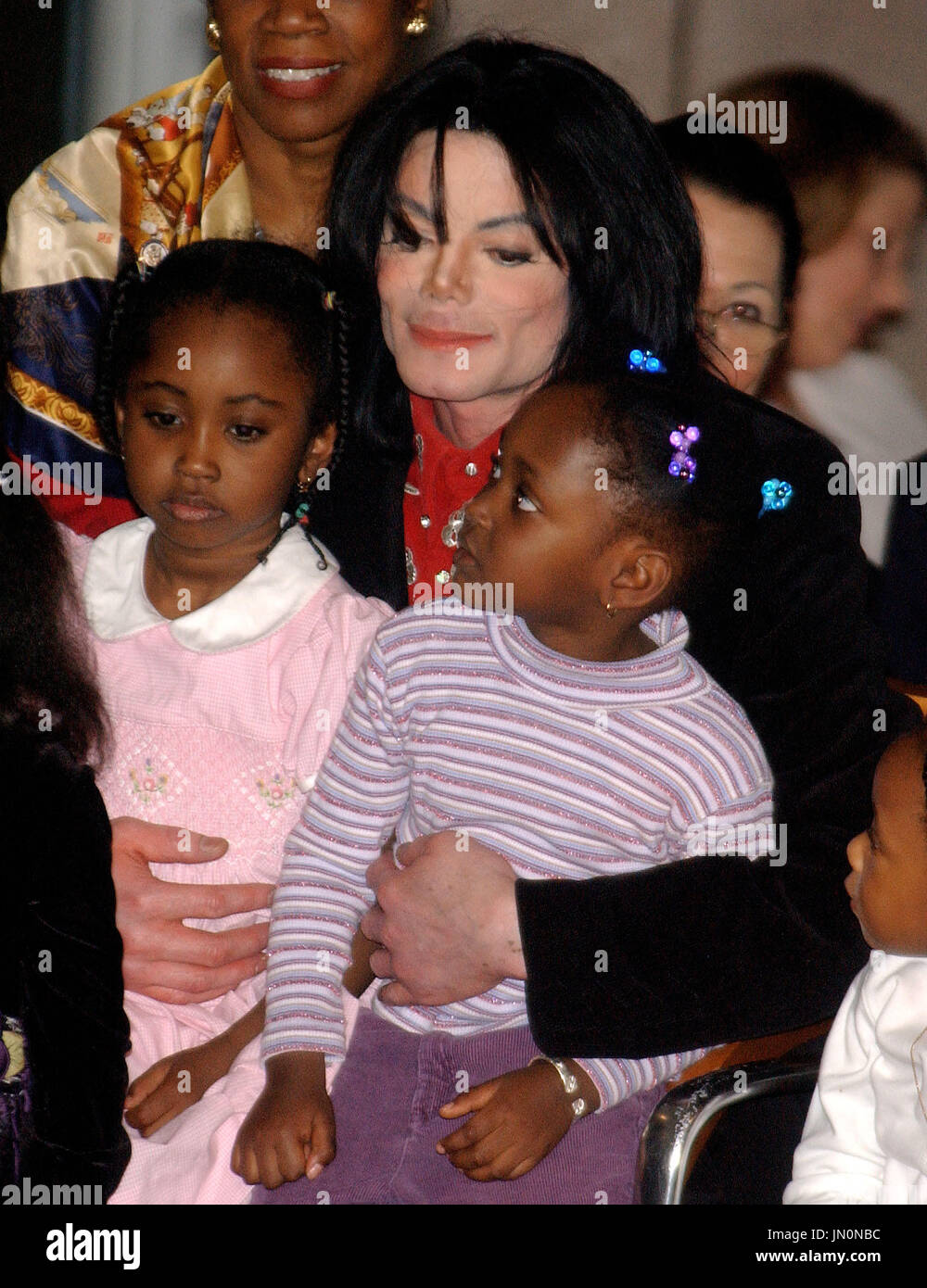 Recording Superstar Michael Jackson hufgs unidentified children at the Embassy of Ethiopia in  Washington, D.C. on April 1, 2004.  He was there to receive the Humanitarian Award from The African Ambassadors' Spouses Association for his worldwide humanitarian efforts, particularly in Africa.  His charitable contributions have been in excess of 50 million US dollars worldwide during his lifetime..Credit: Ron Sachs / CNP Stock Photo