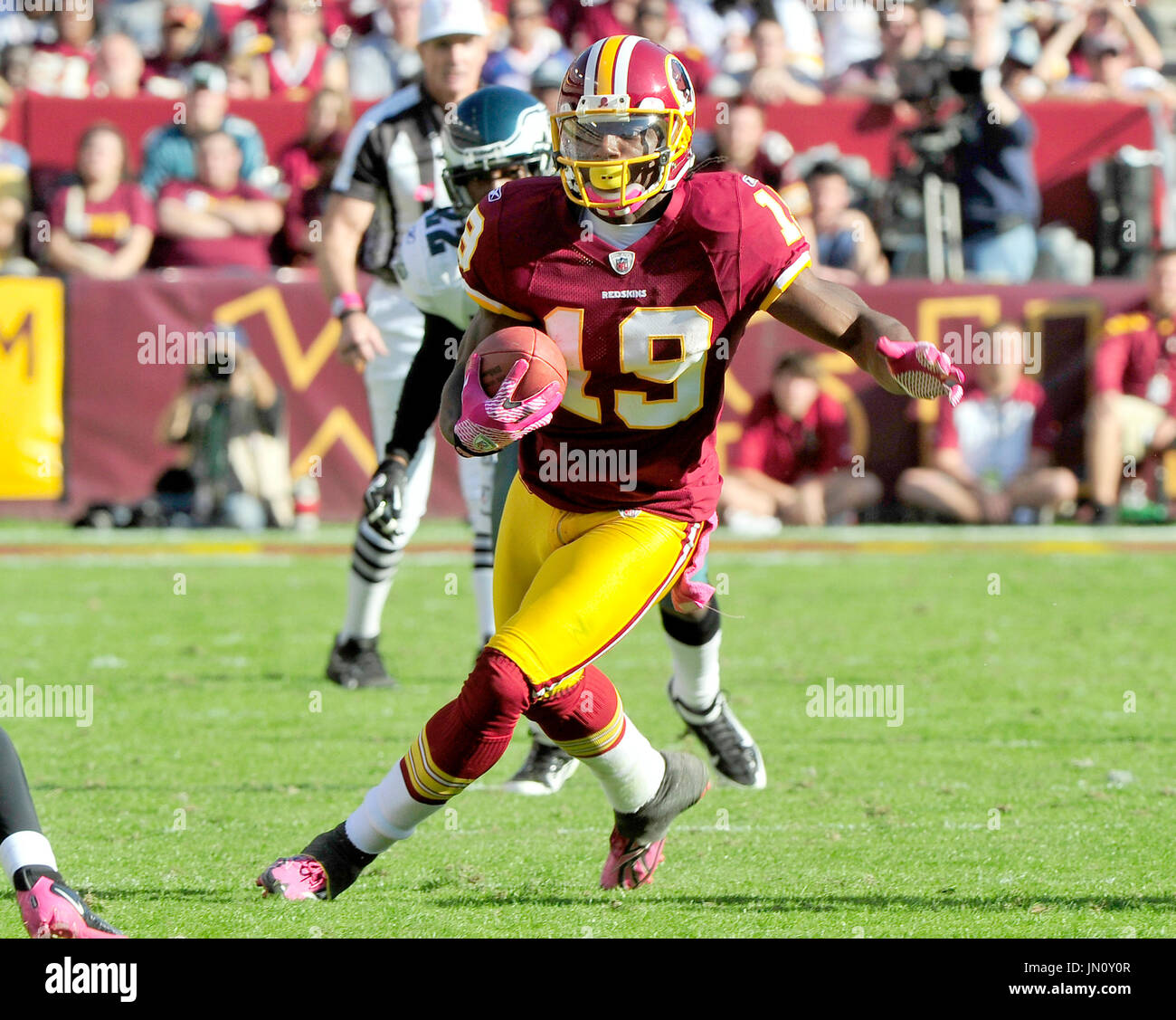 Washington Redskins wide receiver Donte' Stallworth (19) is tackled by New  England Patriots cornerback Devin McCourty (32), rear, Julian Edelman (11)  during the first half at FedEx Field in Landover, MD, Sunday