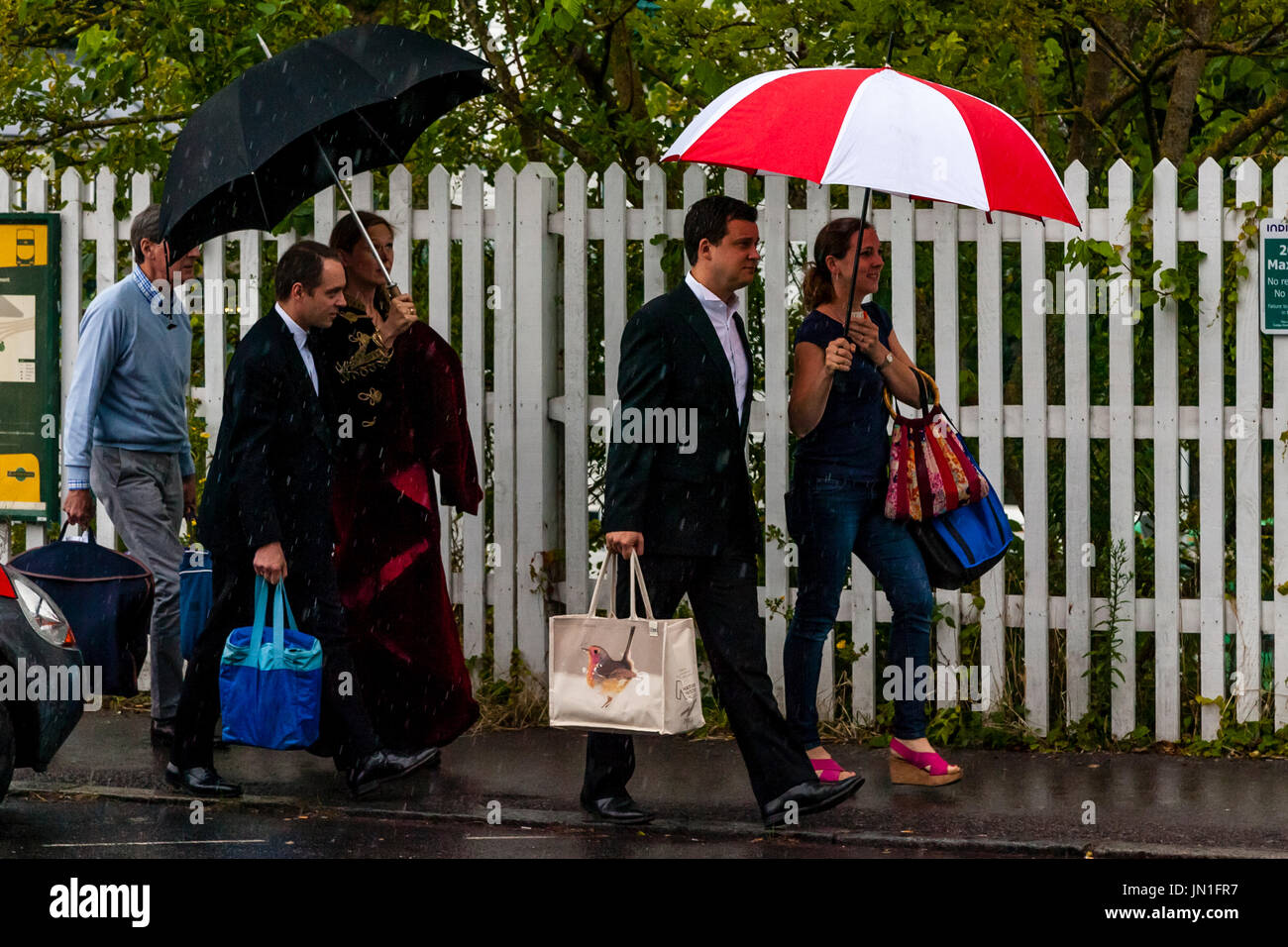 Lewes, UK. 29th July 2017. Opera fans arrive at Lewes train station in the rain en route to Glyndebourne Opera House for a performance of La clemenza di Tito, Lewes, East Sussex, UK.  Credit: Grant Rooney/Alamy Live News Stock Photo