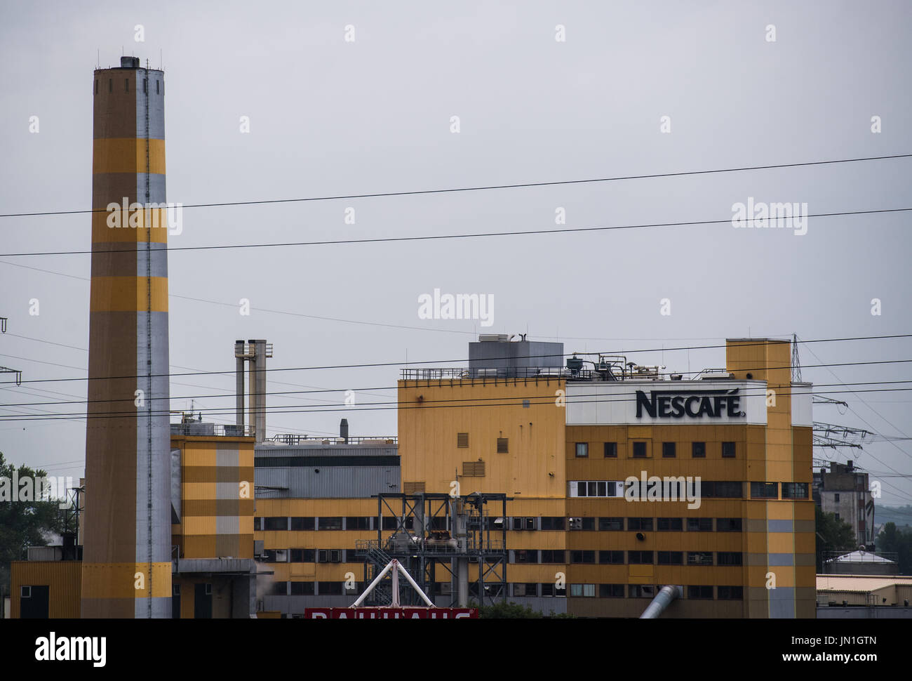 Mainz, Germany. 25th July, 2017. The Nestlé factory in Mainz, Germany, 25 July 2017. Nestlé AG produces products including Nescafe, the brand name on the building's facade, in the factory. Photo: Andreas Arnold/dpa/Alamy Live News Stock Photo
