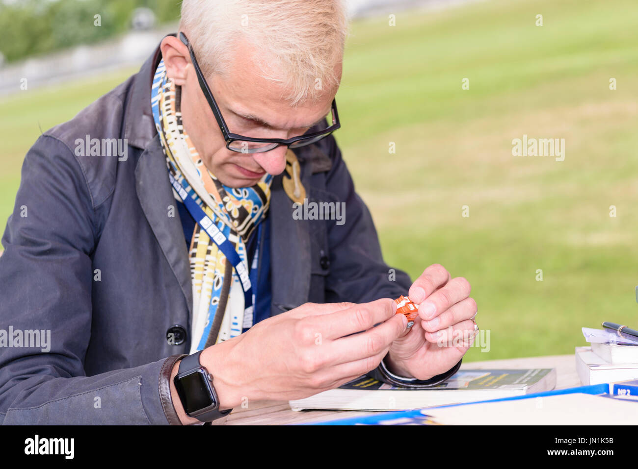 Belfast, Northern Ireland.  29/07/2017 - Antiques expert Mark Hill examines a small toy car as the Antiques Roadshow comes to Stormont Estate. Stock Photo