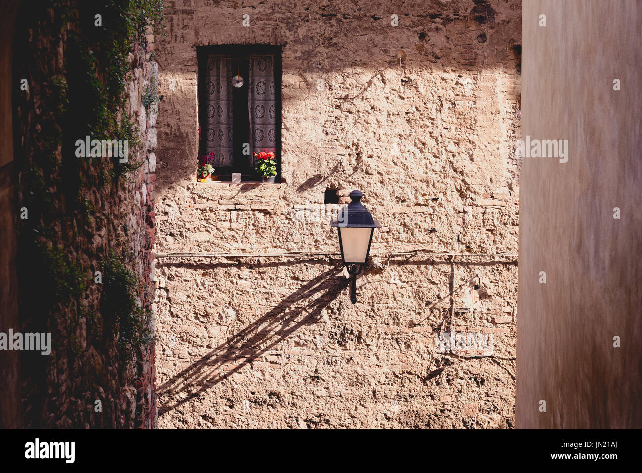 Window and a street lamp in the historic district of Colle val d'Elsa in Tuscany, Italy Stock Photo