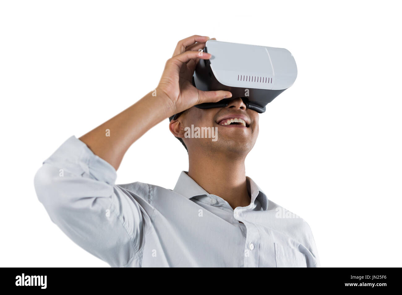 Man using virtual reality headset against white background Stock Photo ...