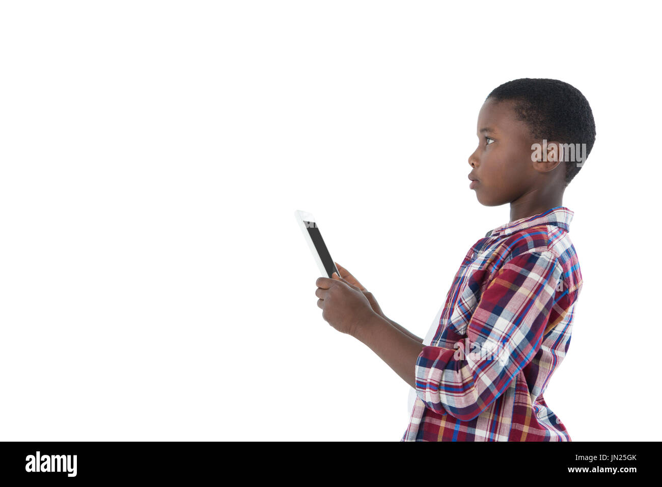Boy using digital tablet against white background Stock Photo - Alamy