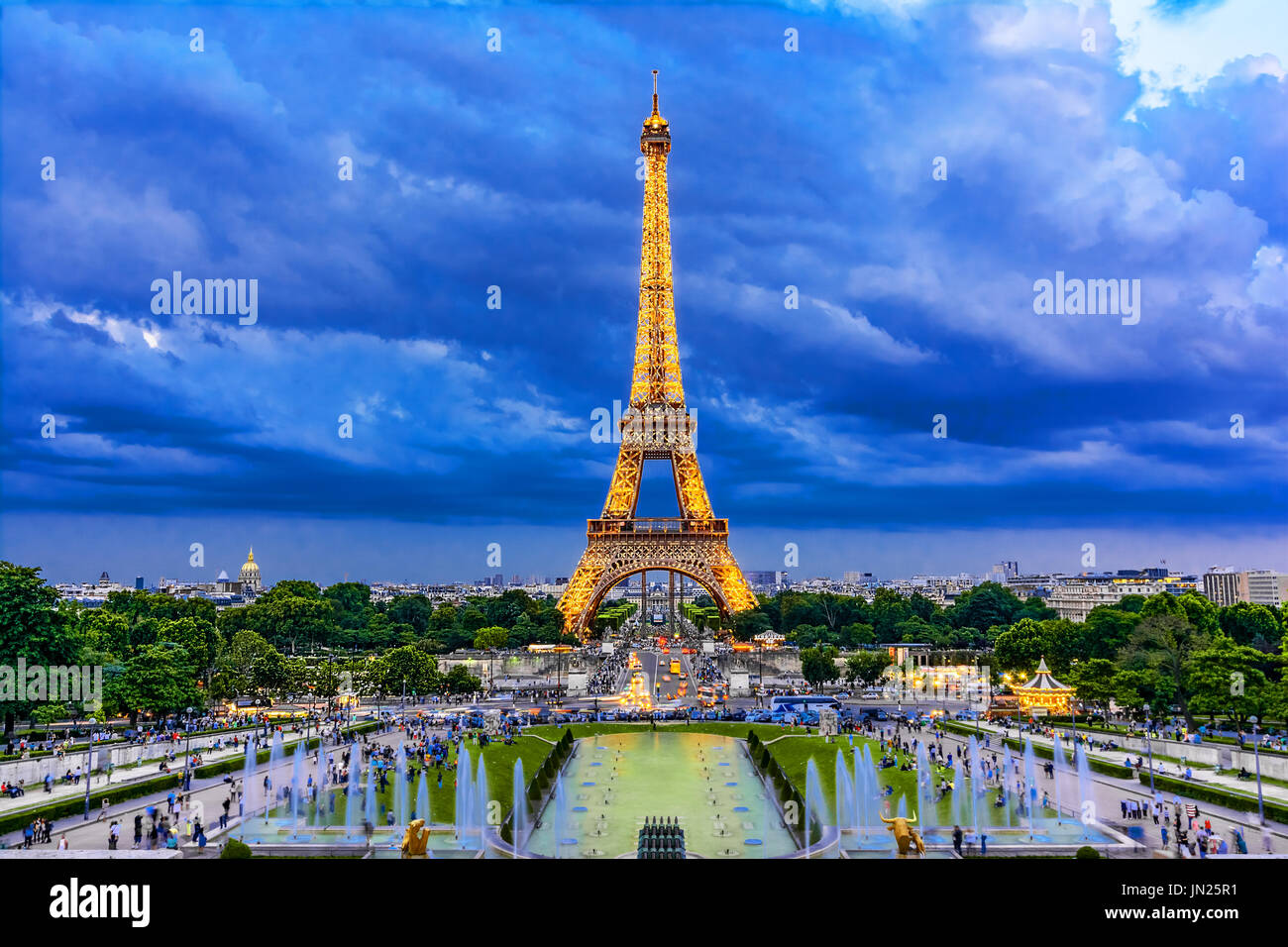 Paris, France - June 8th, 2014: Eiffel Tower illuminated at dusk-during Roland Garros tour. The Eiffel Tower was built in 1889, and is a popular attra Stock Photo