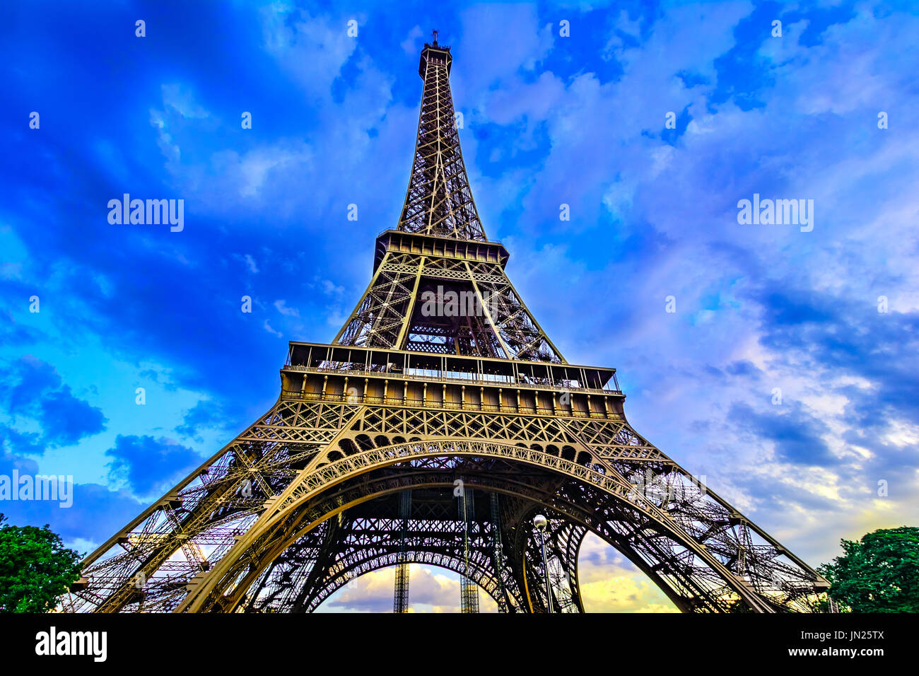 Paris, France, Eiffel Tower, illuminated at sunset The Eiffel Tower was built in 1889, and is a popular attraction for tourists. Stock Photo