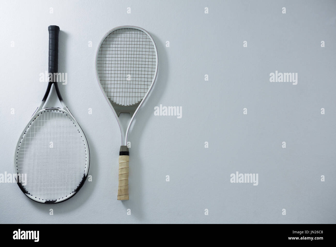 Overhead view of metallic tennis rackets on white background Stock Photo