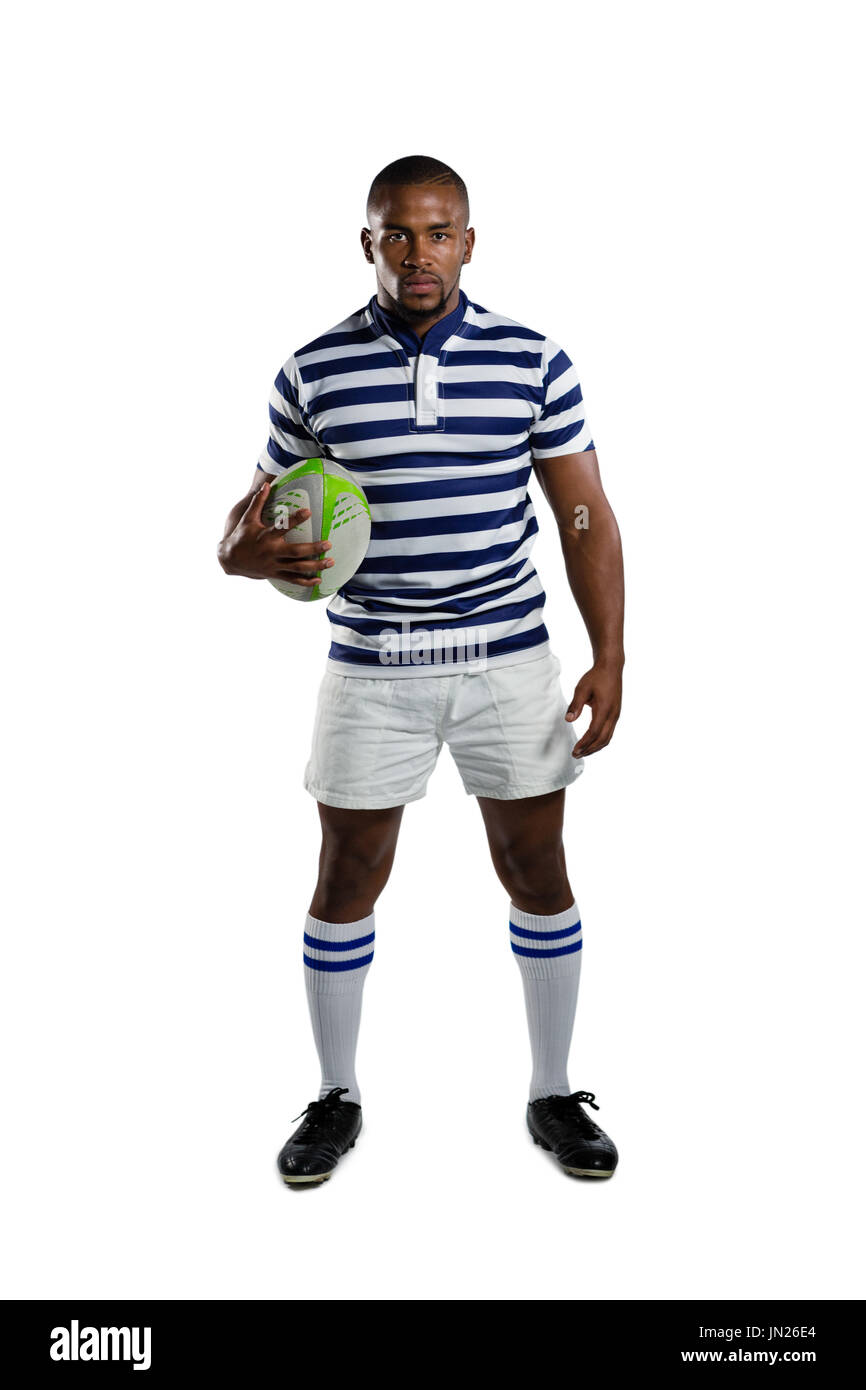 Portrait of sportsman wearing sports uniform holding rugby ball while standing against white background Stock Photo