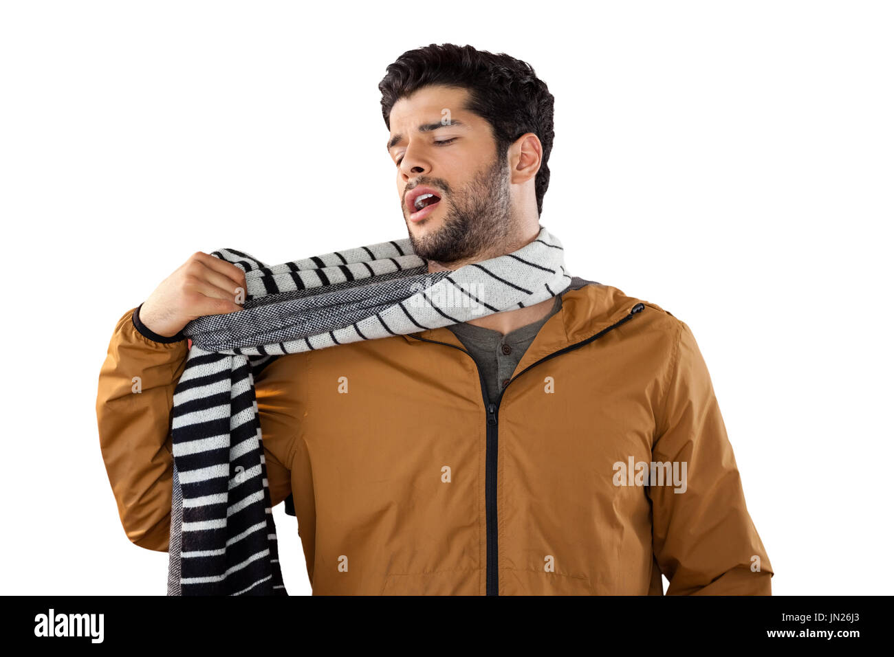 Man looking at his scarf against white background Stock Photo