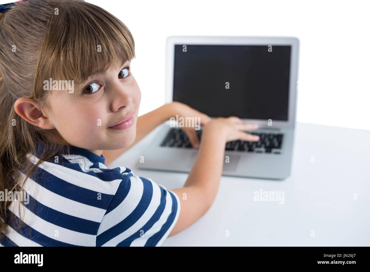 Portrait of cute girl using laptop against white background Stock Photo ...