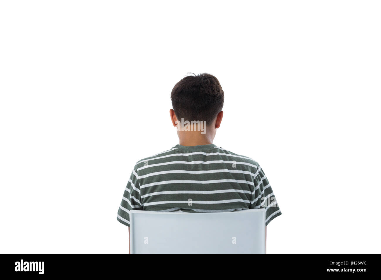 Rear view of boy sitting on chair against white background Stock Photo ...