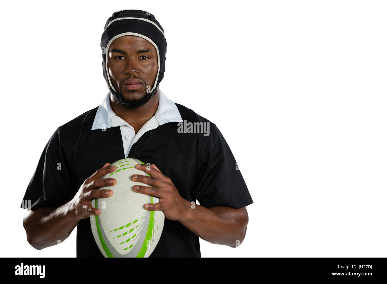 Portrait of male rugby player wearing helmet holding ball while