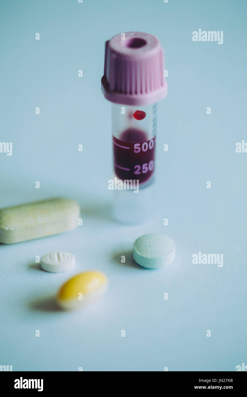 A vial of blood with medicine tablets and pills Stock Photo Alamy