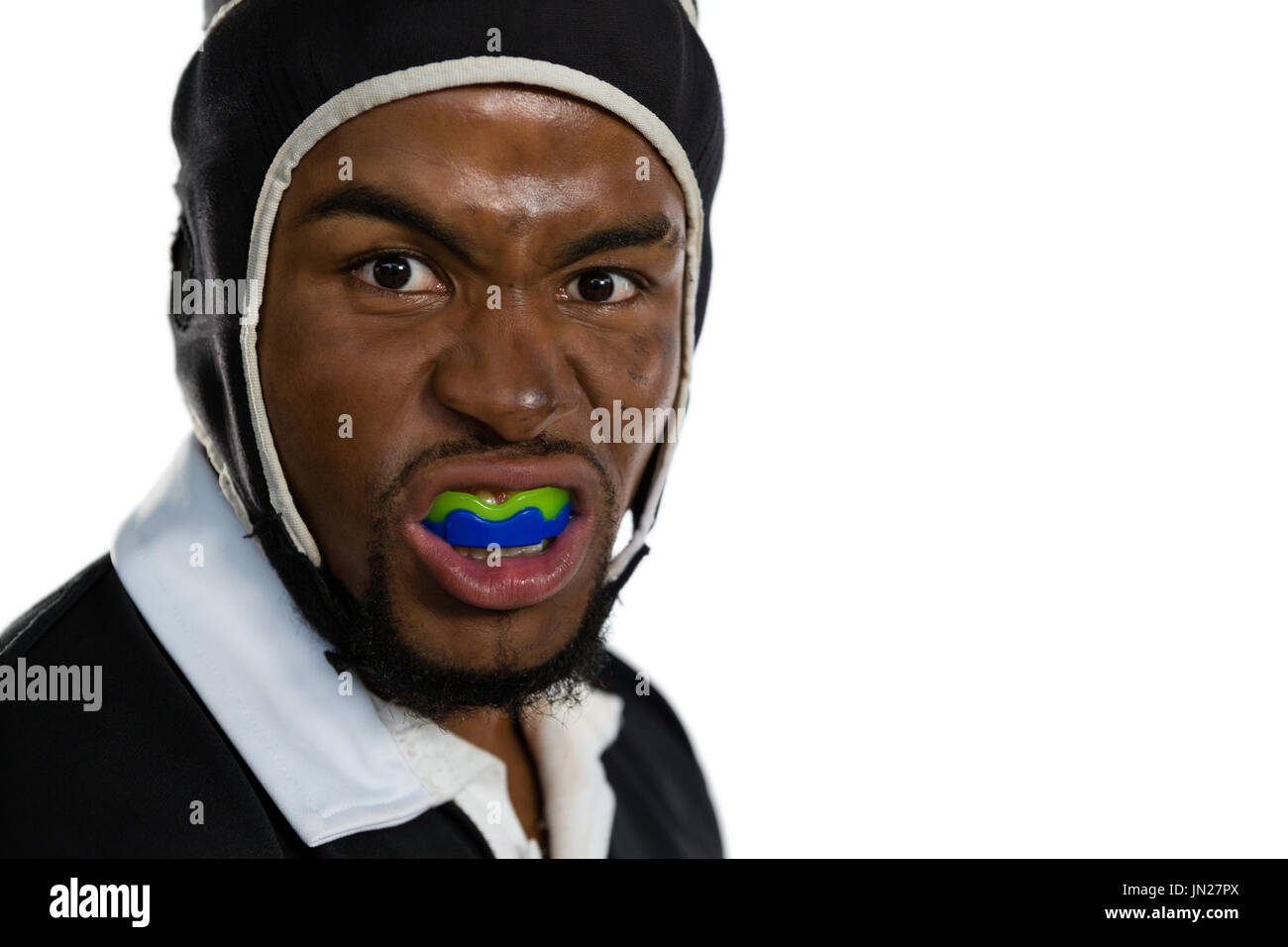 Portrait of male rugby player with mouthguard against white bakground Stock Photo