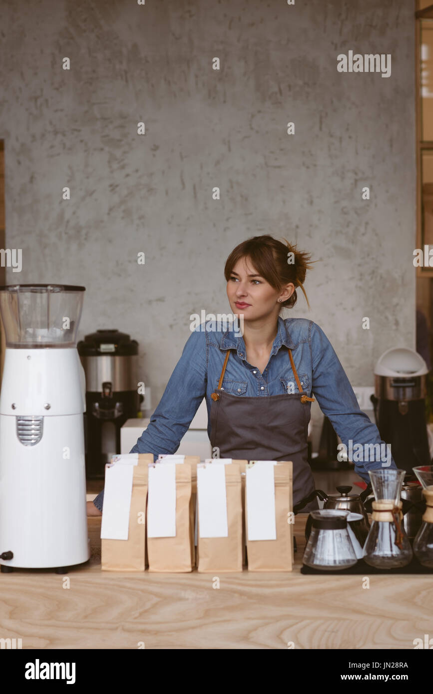 Beautiful waitress standing in cafe Stock Photo