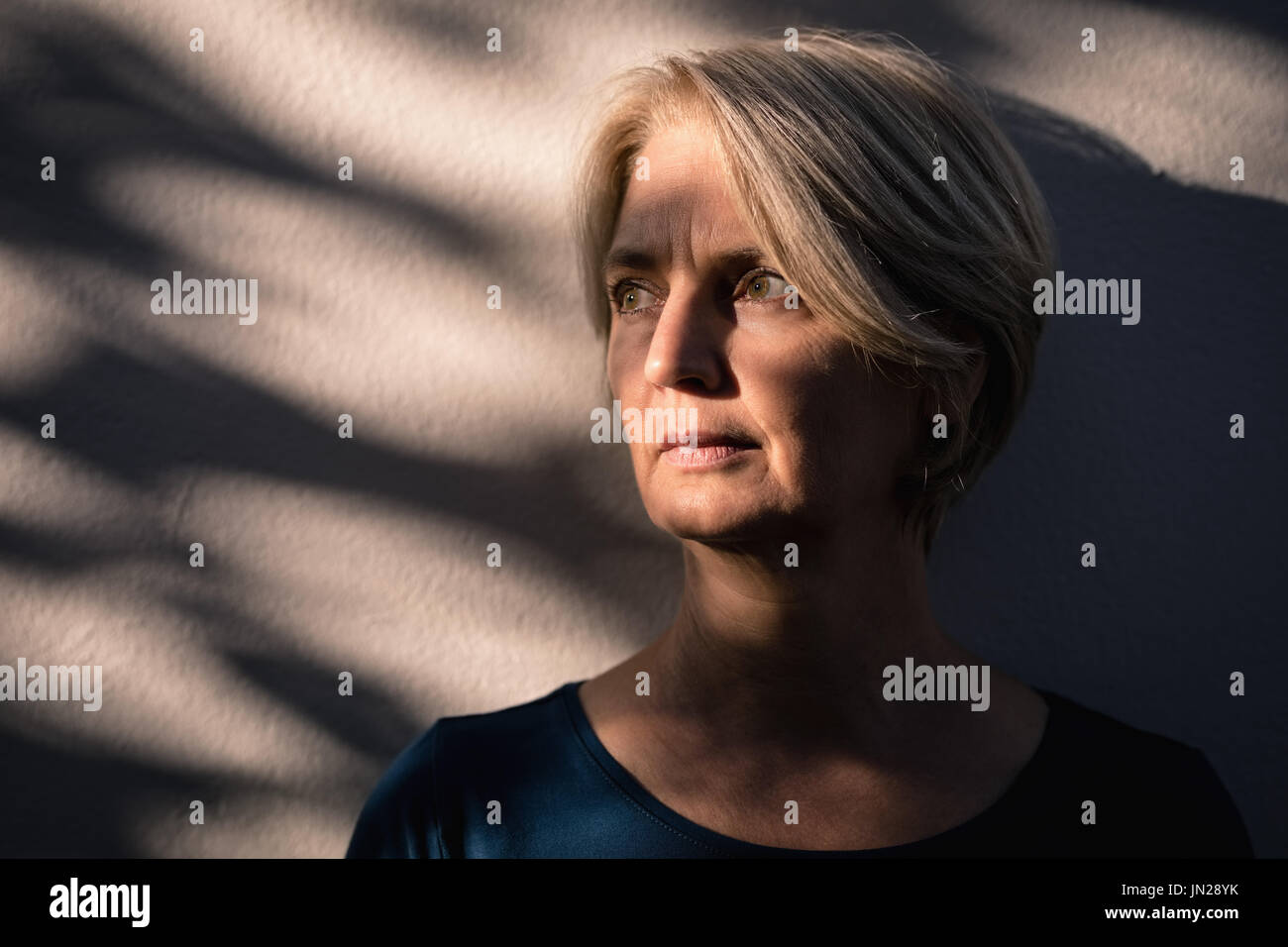 Thoughtful senior woman looking away Stock Photo