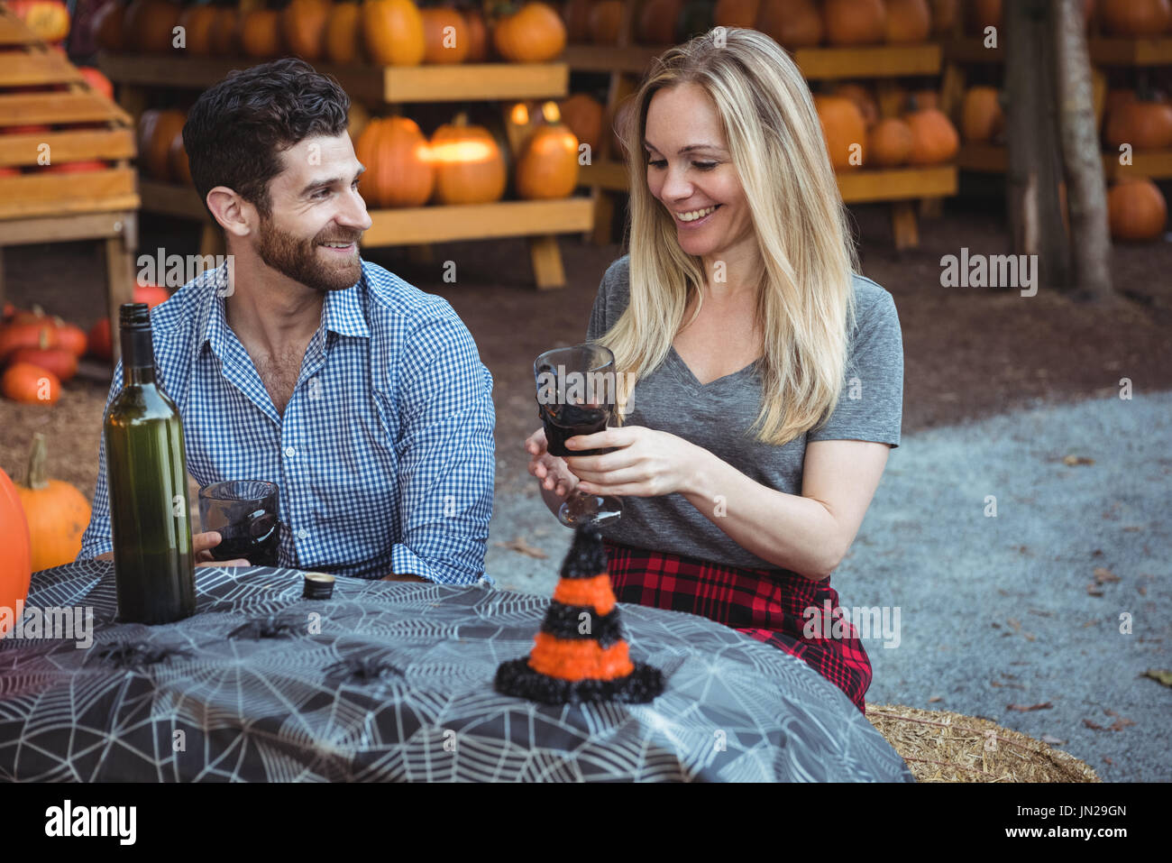 Couple interacting while having a glass of wine Stock Photo - Alamy