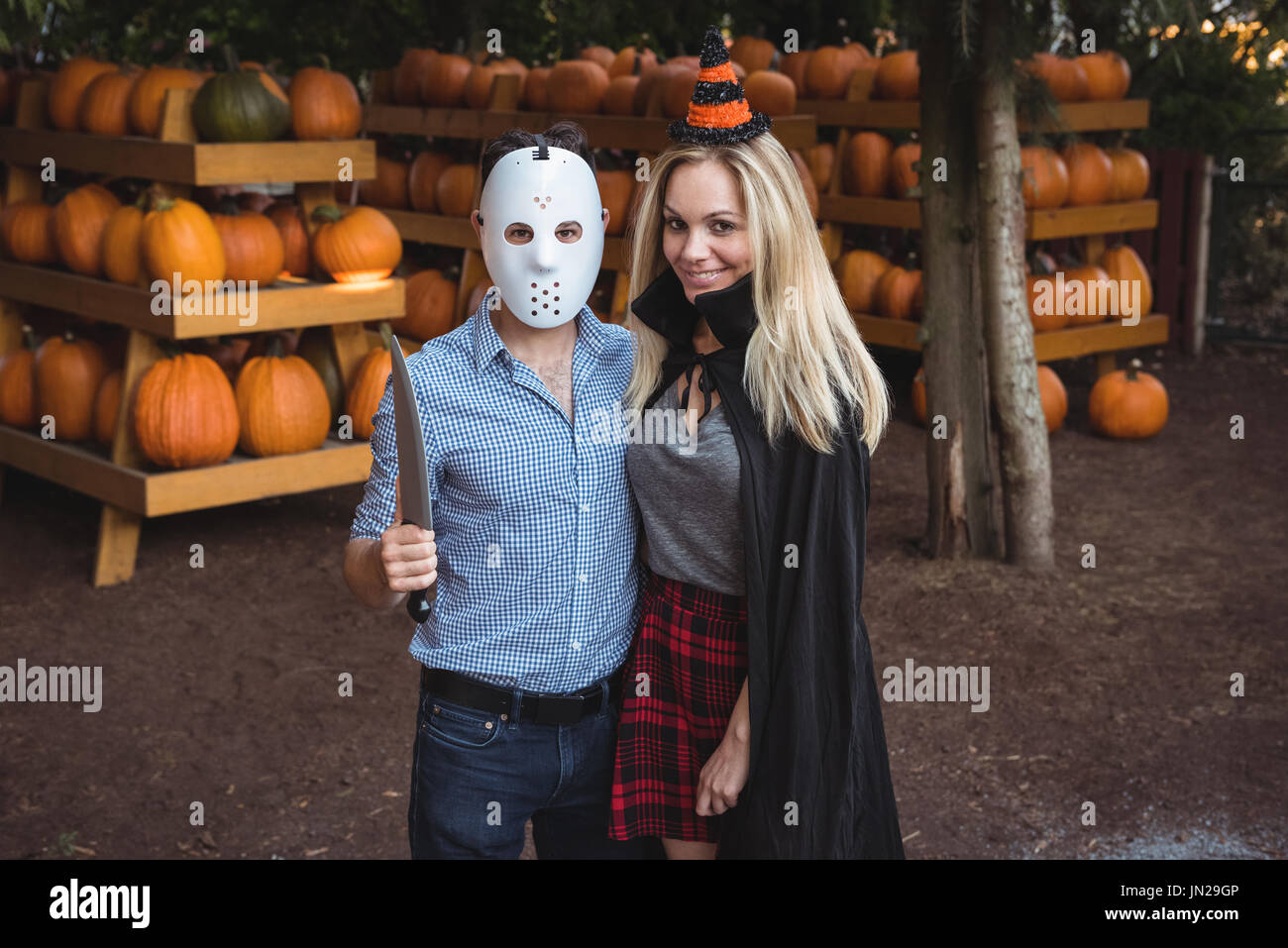 Couple wearing halloween mask and halloween costume Stock Photo - Alamy