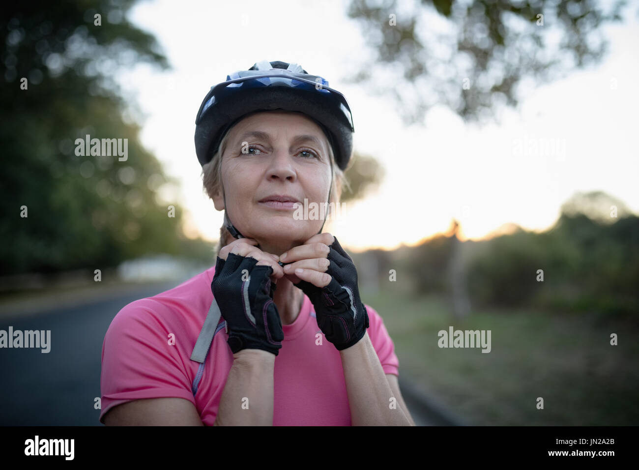 Woman wearing bicycle helmet hi-res stock photography and images - Alamy