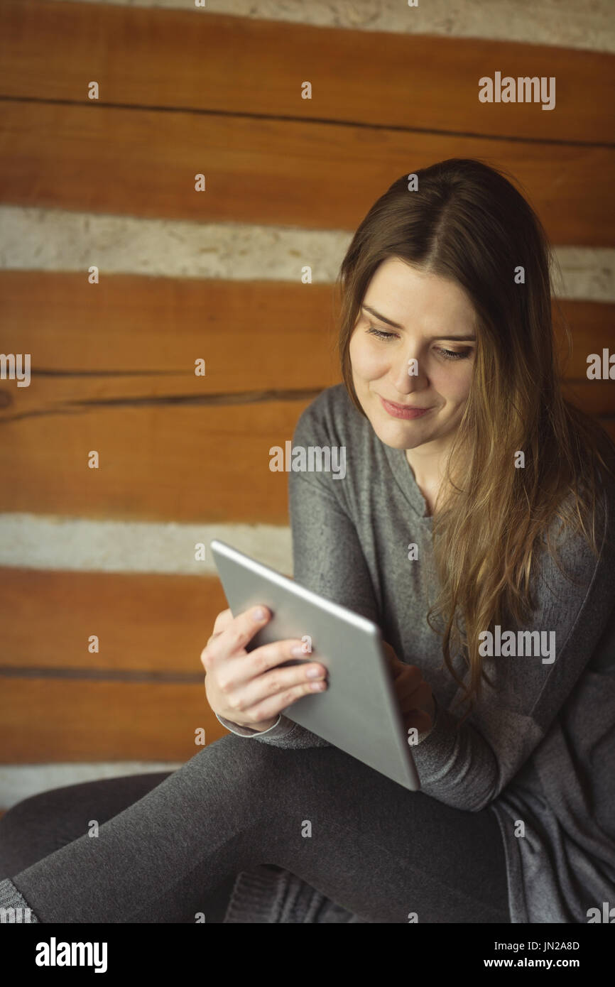 Smiling woman using digital tablet at home Stock Photo