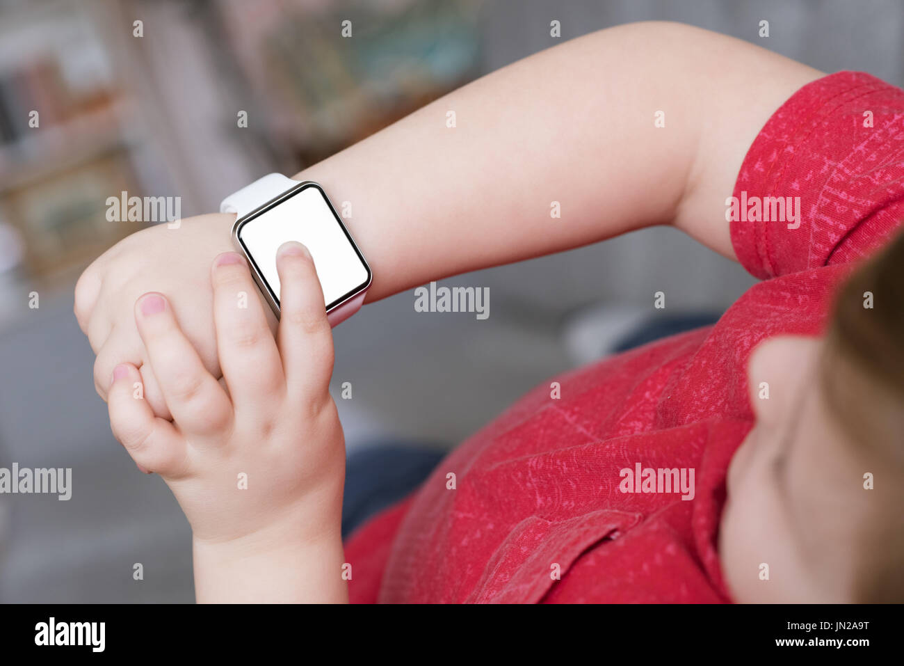 Overhead view of boy using smart watch while standing at home Stock Photo