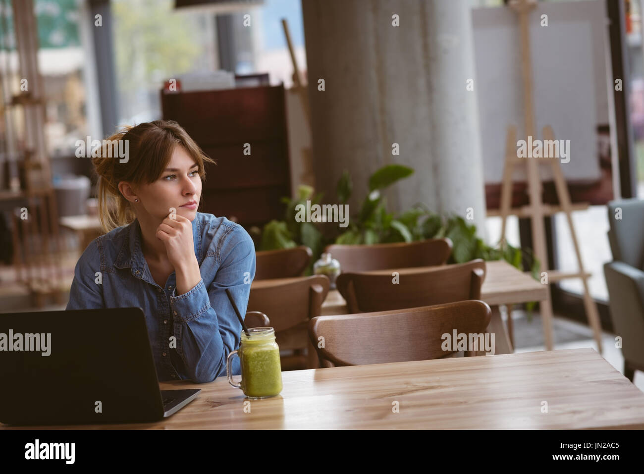 Beautiful woman sitting with laptop in the cafe Stock Photo