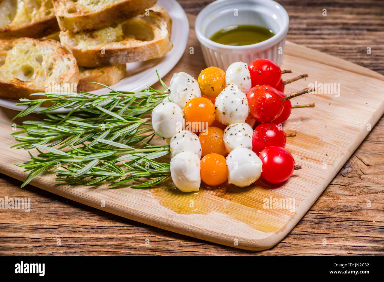 Tomato cheese and bread appetizers on rosemary skewers Stock Photo Alamy
