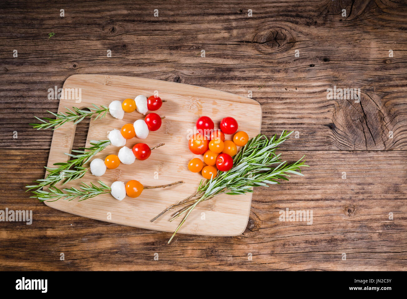 Tomatoes and cheese balls on rosemary skewers Stock Photo