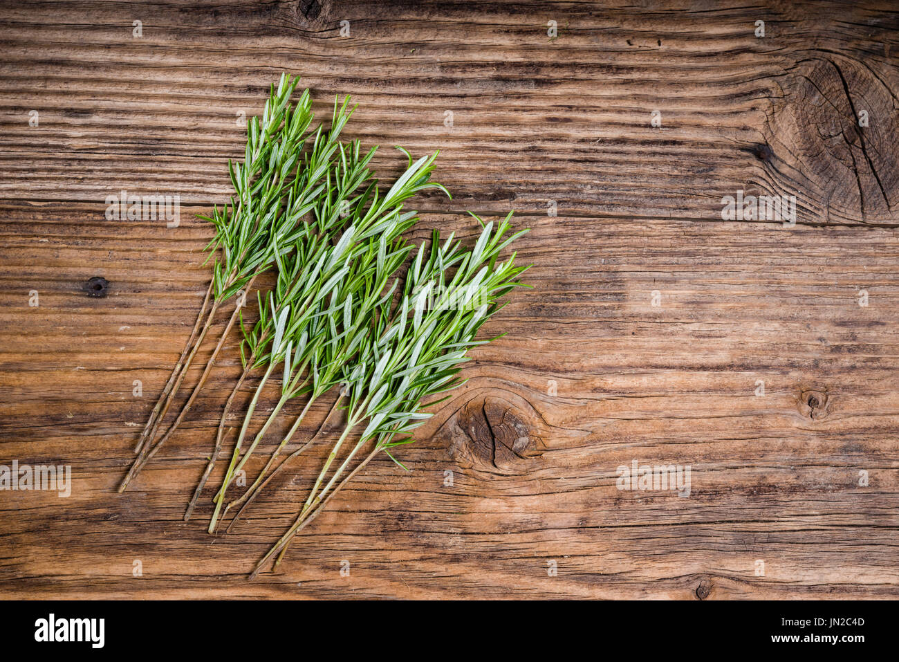 Stems of rosemary herb for skewers on a wooden table Stock Photo Alamy