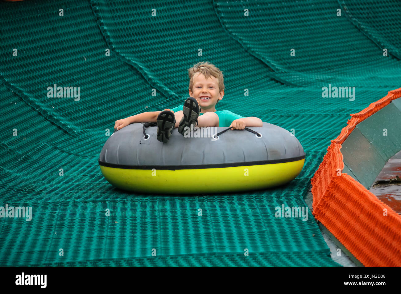 Inflatable slide boy sliding down fun hi-res stock photography and ...