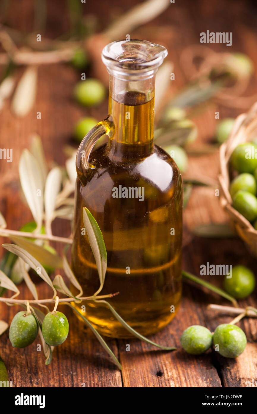Olive oil and olives on wooden rustic table Stock Photo - Alamy