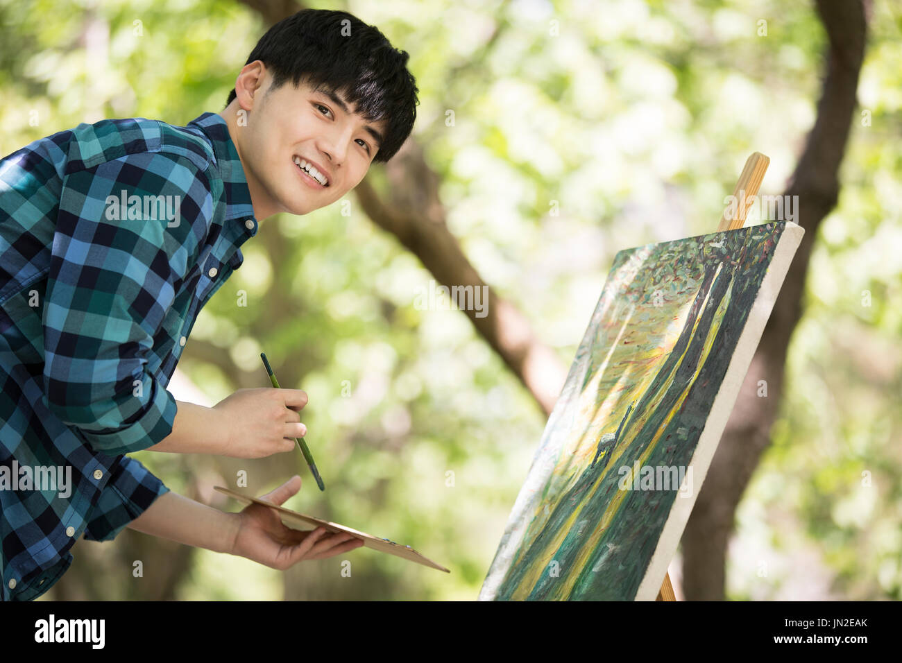 Young man painting outdoors Stock Photo