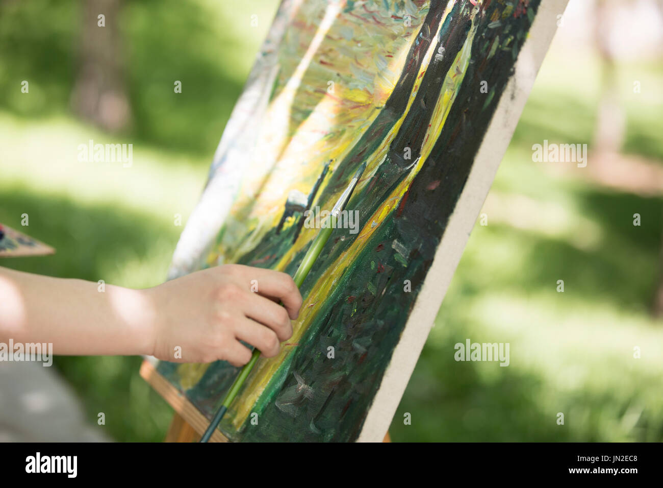 Young man painting outdoors Stock Photo