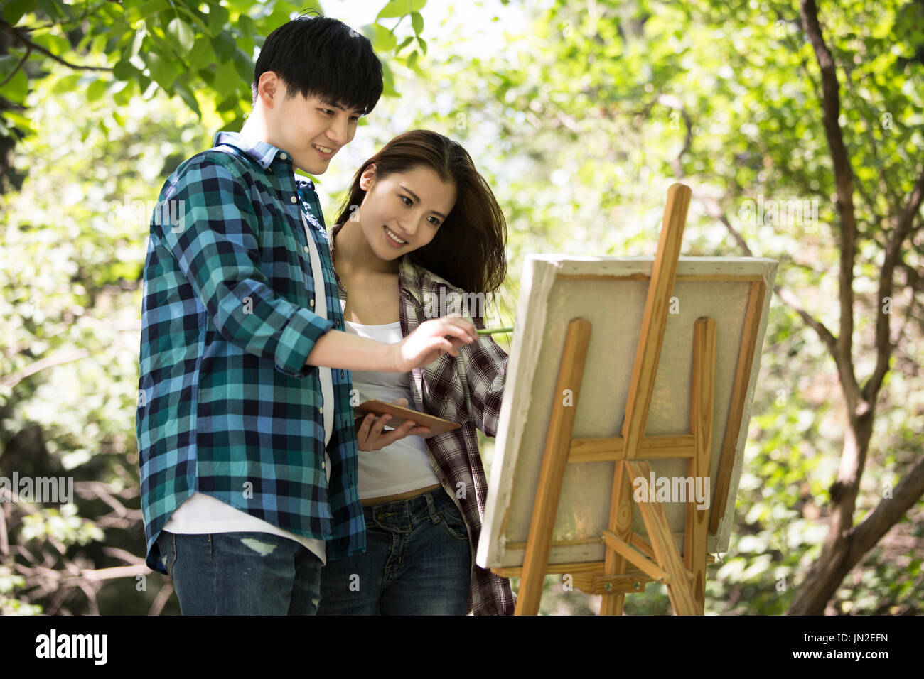 Young couple painting outdoors Stock Photo