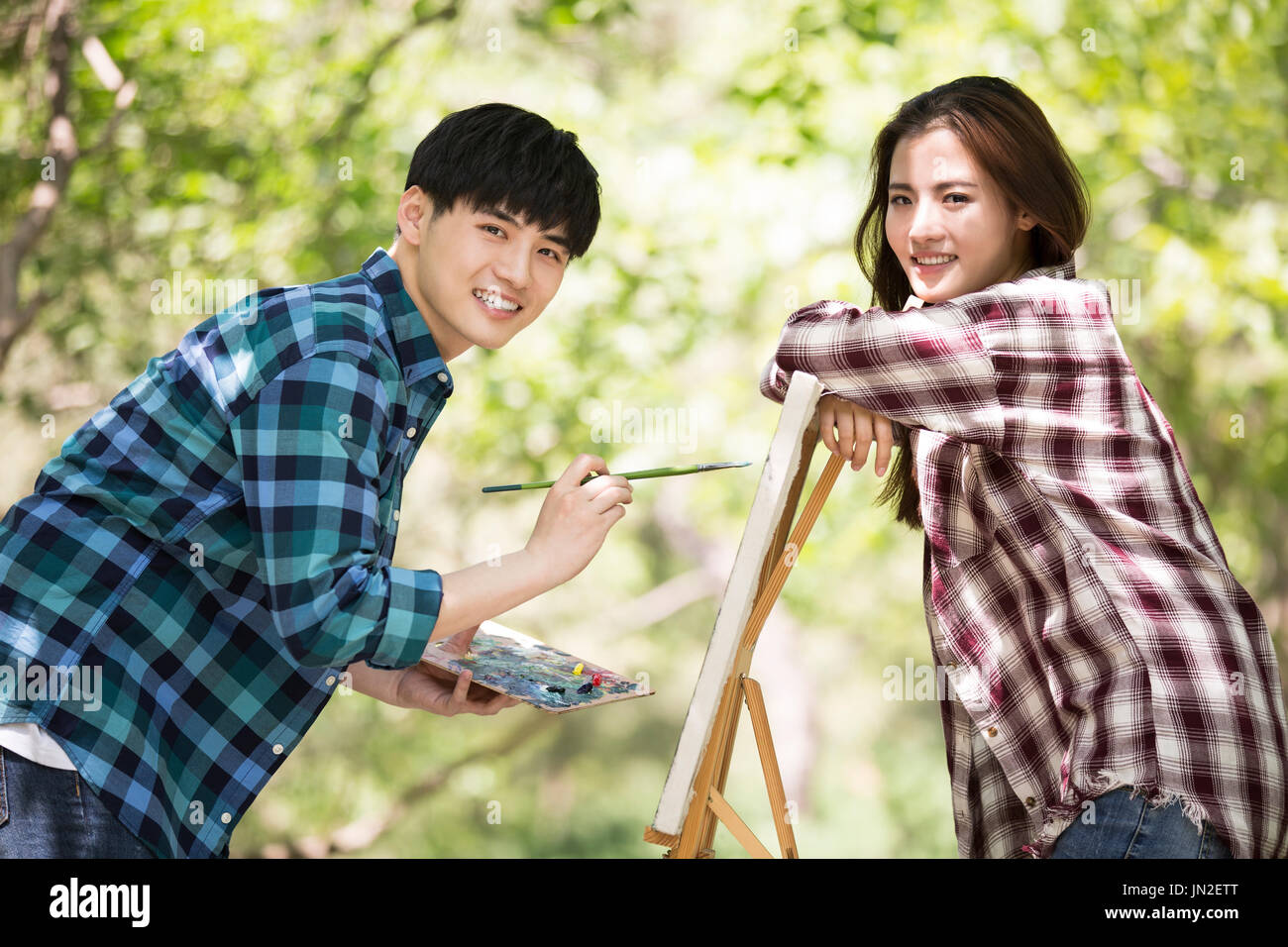 Young couple painting outdoors Stock Photo