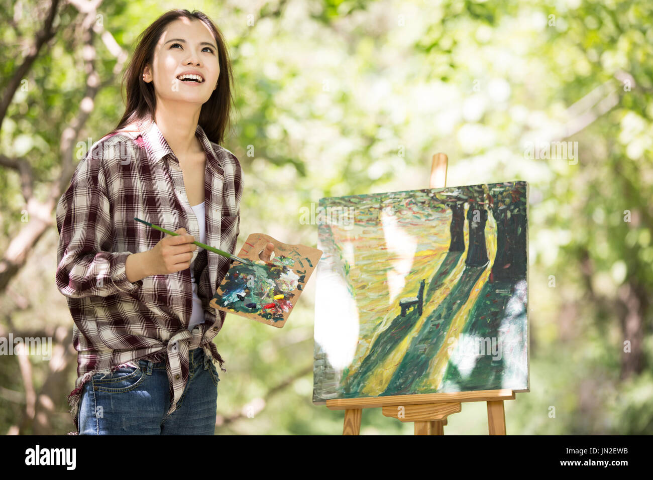 Young woman painting outdoors Stock Photo