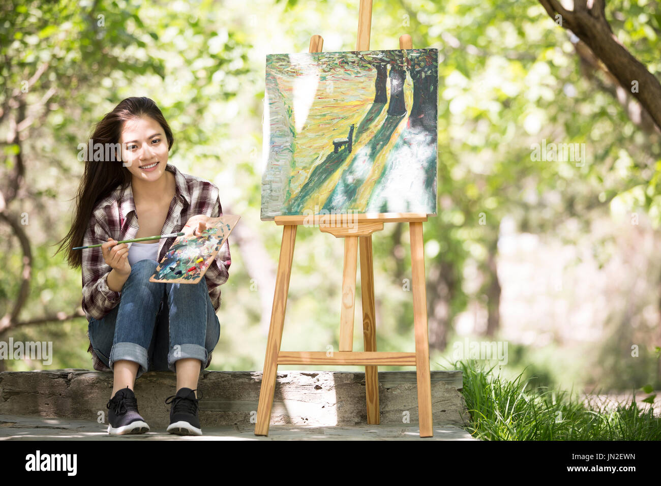 Young woman painting outdoors Stock Photo