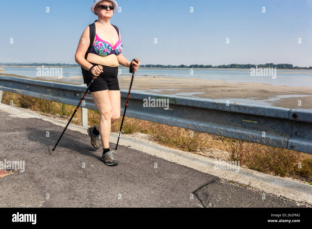 Senior woman nordic walking along the Danube river Slovakia Active aging Stock Photo