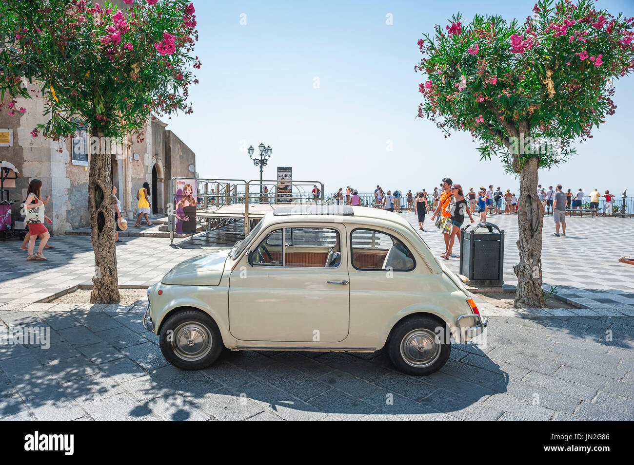 Fiat 500 old car, view of a classic Fiat 500 Cinquecento parked in Piazza IX Aprile in the historic resort town of Taormina, Sicily. Stock Photo